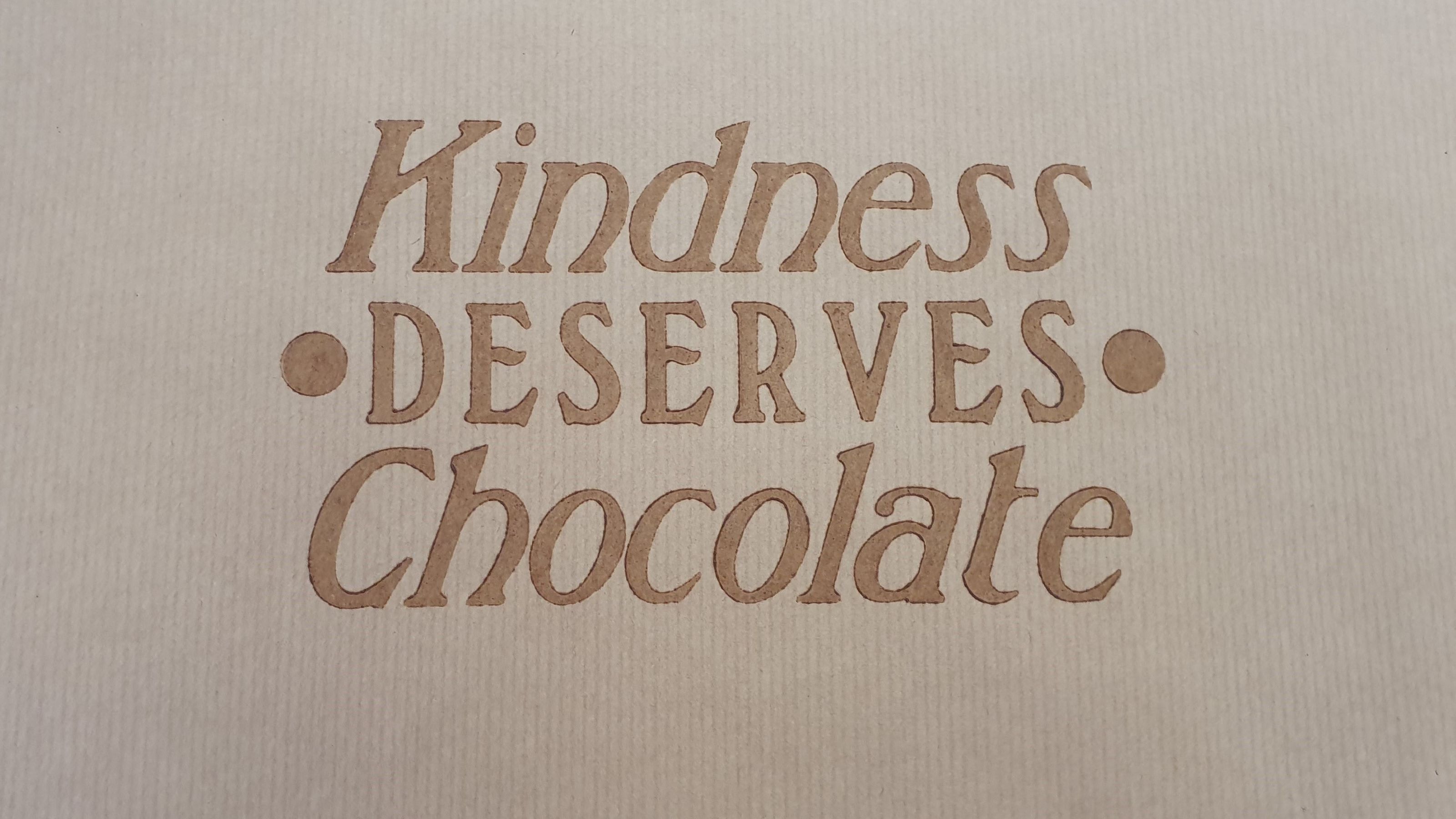 "Kindness deserves chocolate" printed with chocolate as ink.