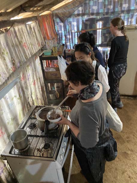 Students in village kitchen