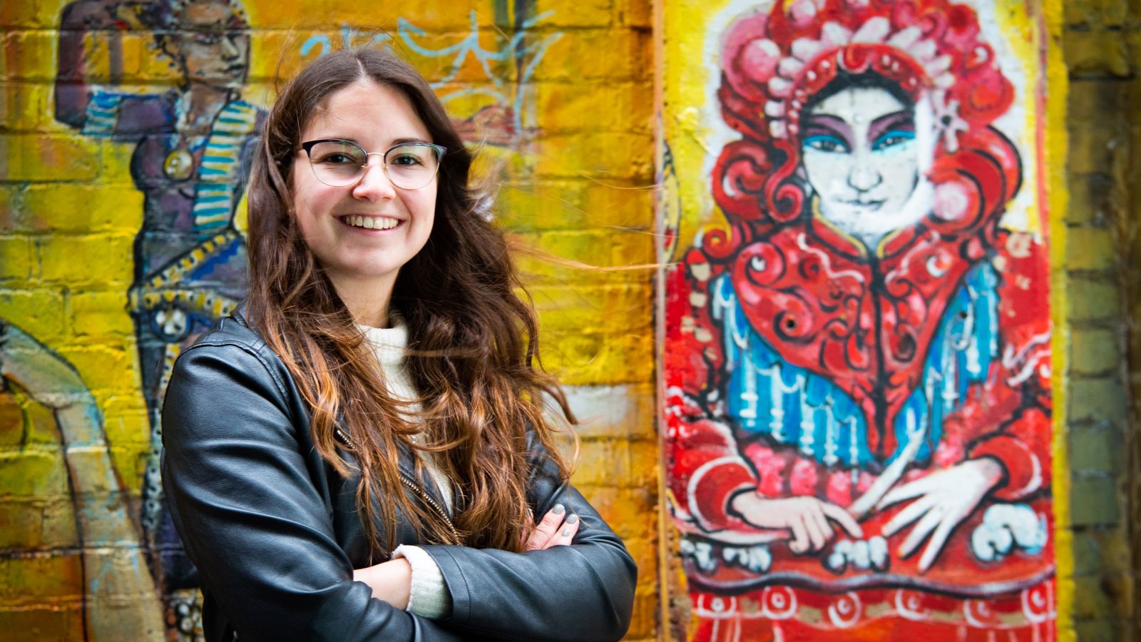 Mariana Restrepo Sierra in front of graffiti