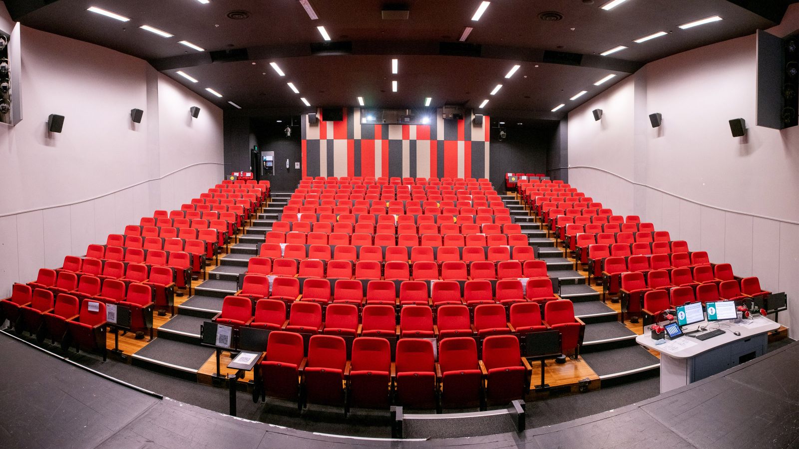 View of Memorial Theatre from front of auditorium. Shows bank of tiered red coloured seating.