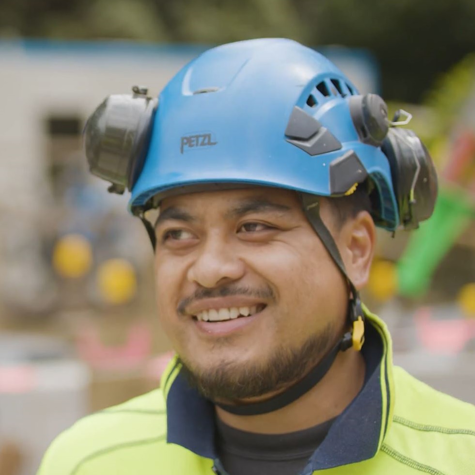Head and shoulders portrait of Pasifika man wearing safety gear,