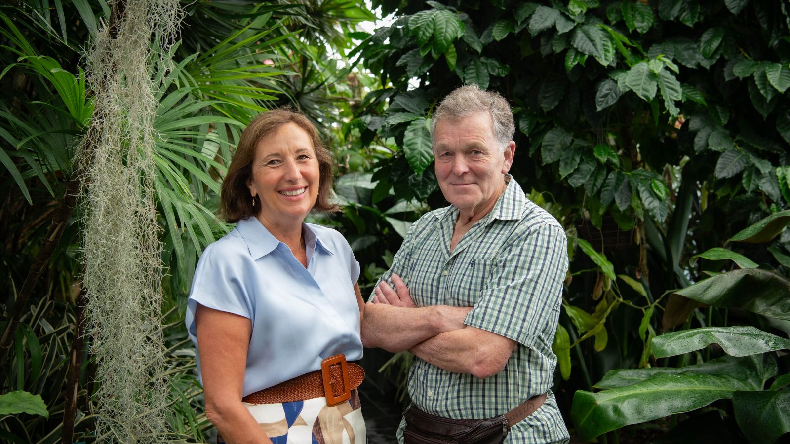 Friends of Wellington Botanic Garden committee members Mazz Scannell and Reg Harris standing in front of plants in the Begonia House