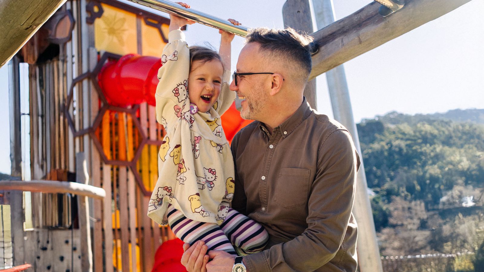 child with parent on the playground