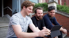 Steffan Paton, Jack Hooker and Kenyon Shankie sitting on Hunter steps holding tablet