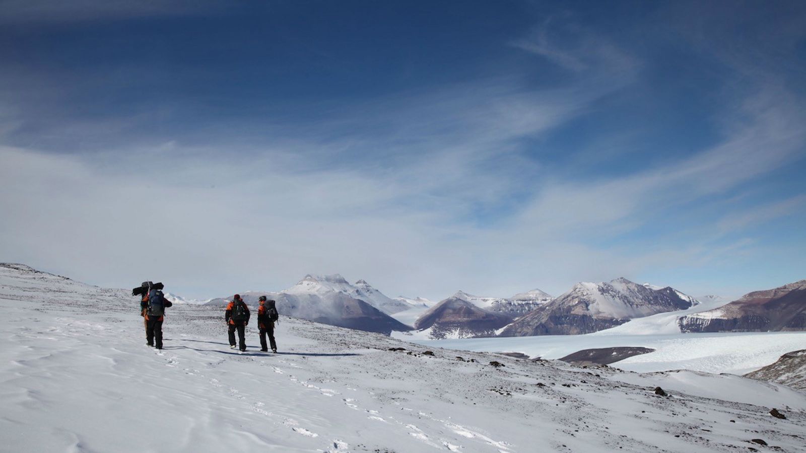 Image of 3 researchers walking on the ice