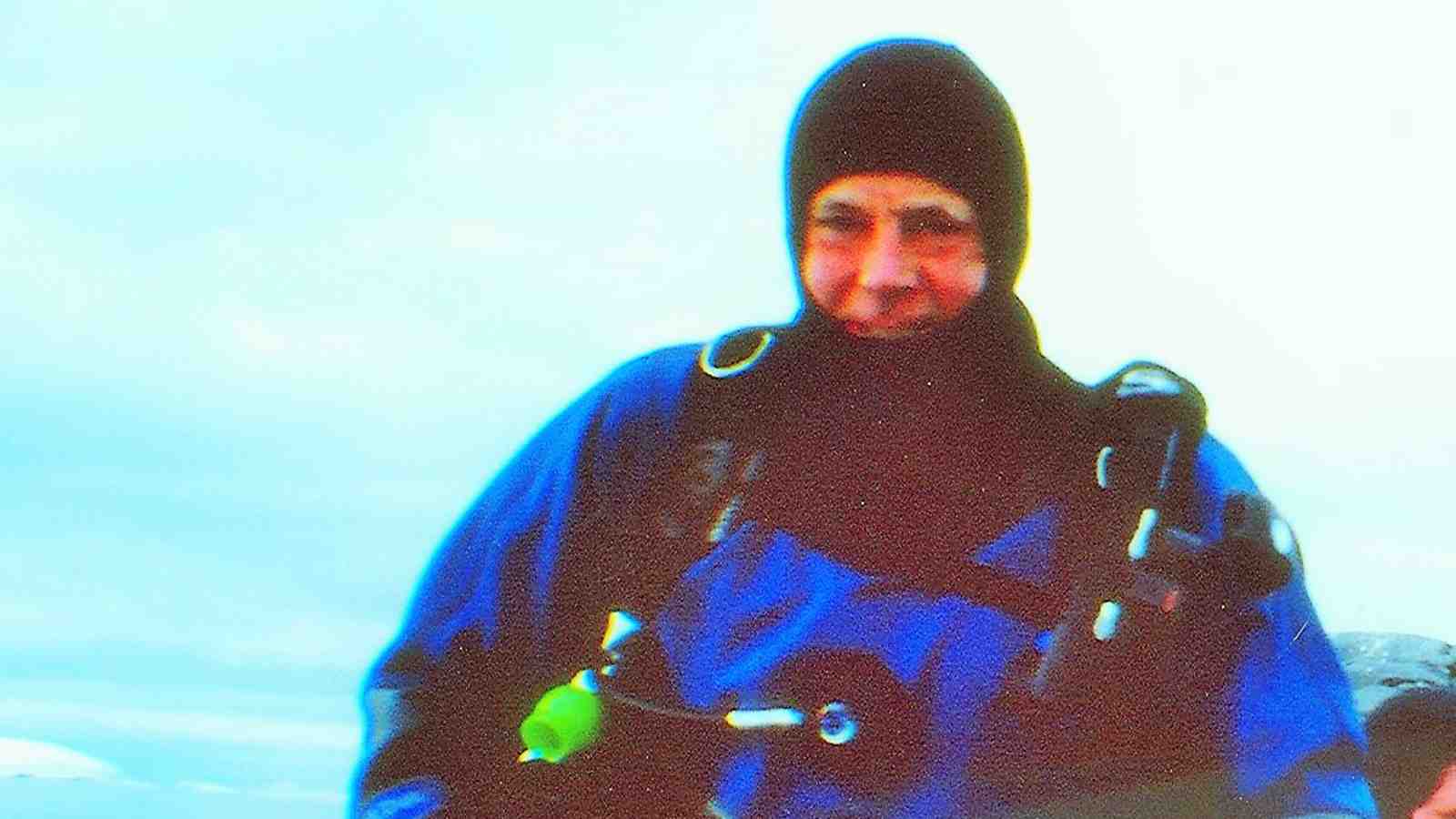 Sir Neville Jordan in Antarctica wearing a drysuit for scuba diving.