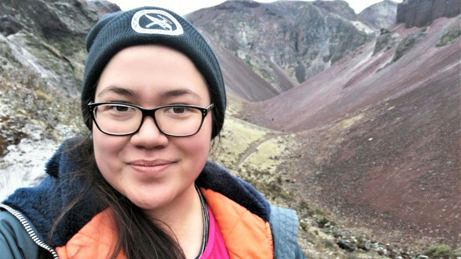 Raiatea stands in front of rocky hills