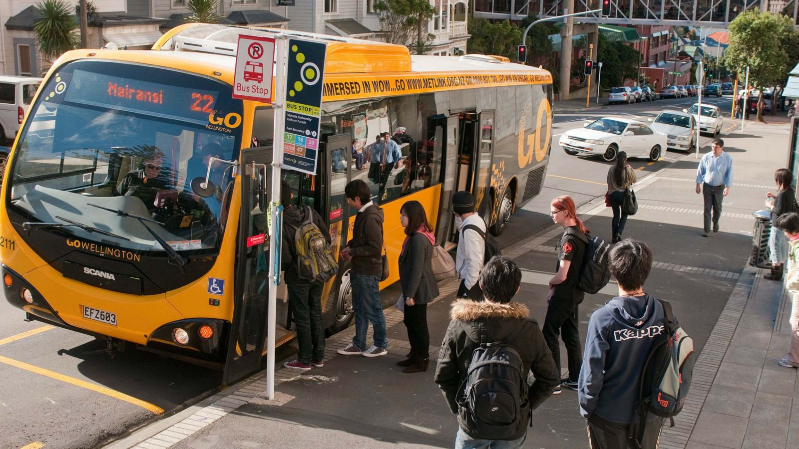 Some students are waiting at the bus stop on Kelburn Parade and others are lining up to board the number 22 Mairangi bus.