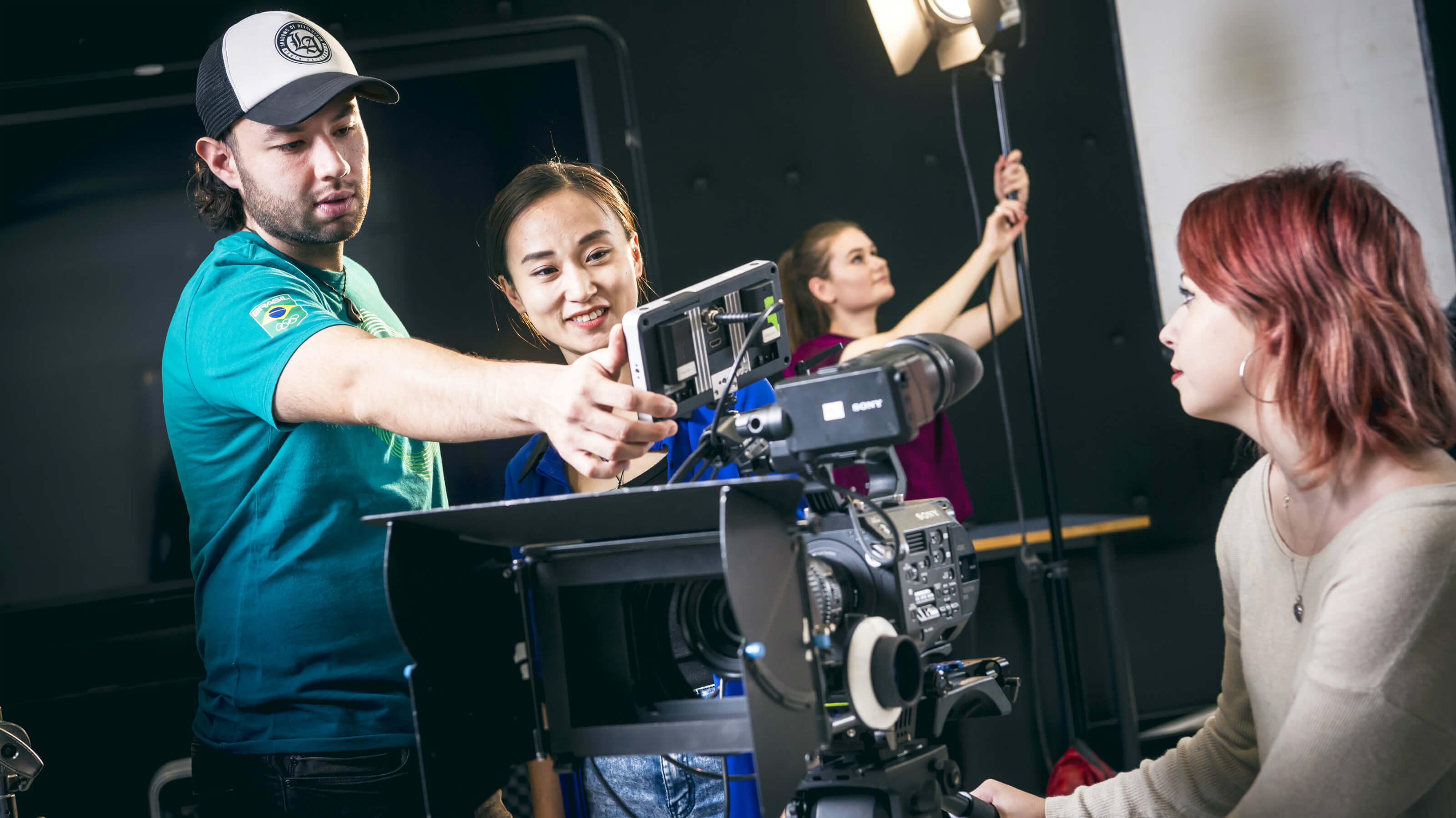 Four film students working on a set at the Miramar Creative Centre.