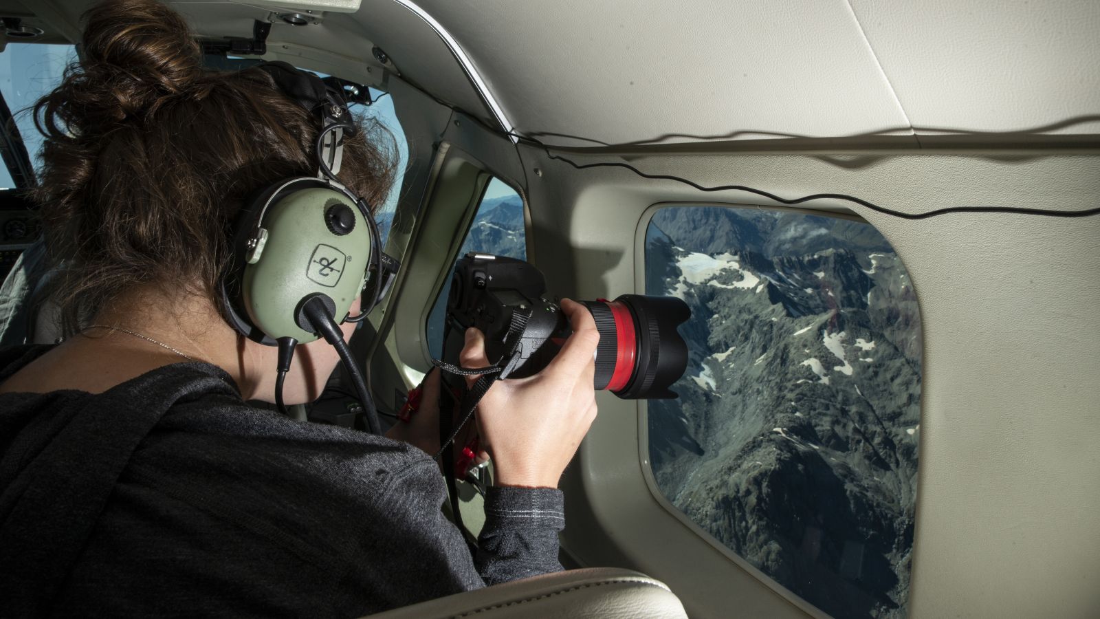 Lauren Vargo taking photos from a plane for glacier monitoring. Photo credit: Rebekah Parsons-King