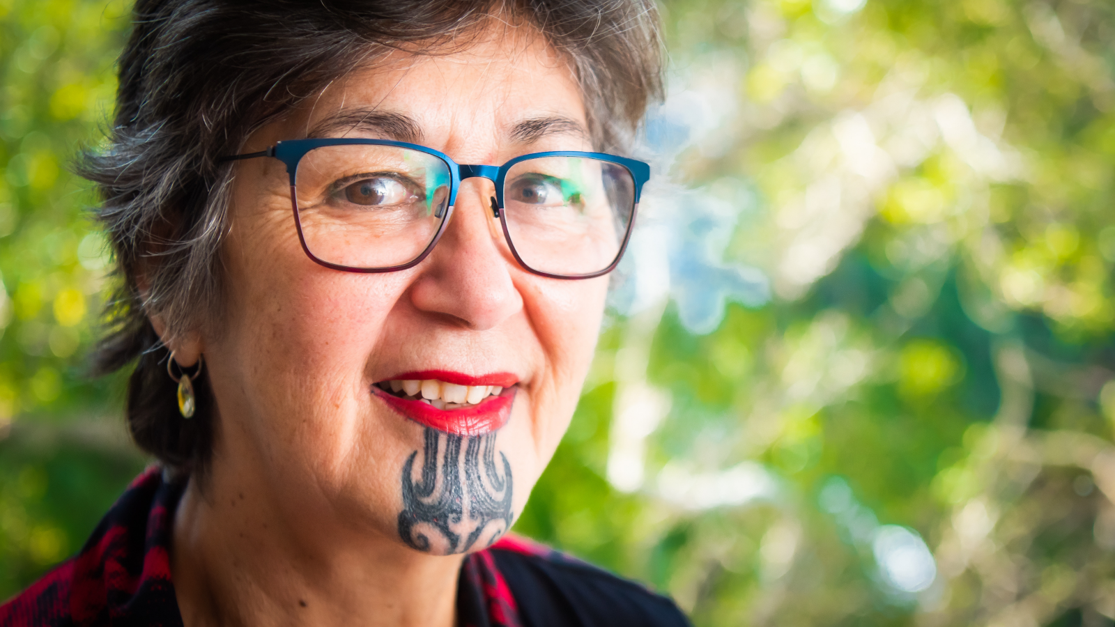 close up of face with te moko Māori tattoo and glasses 