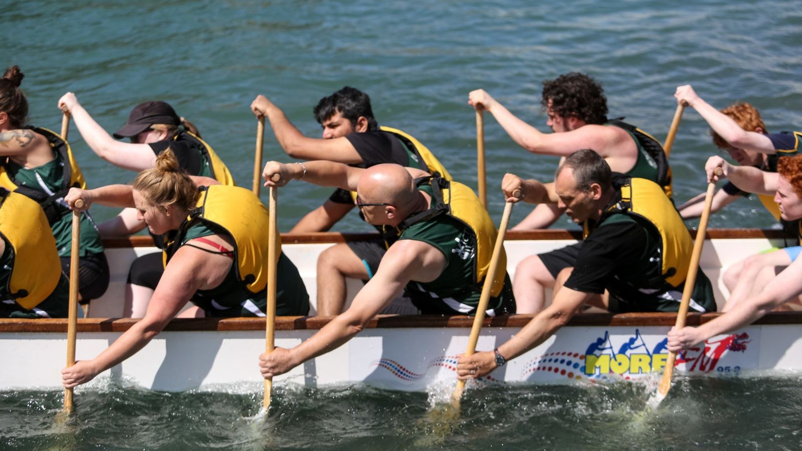 Team paddling on dragon boat.
