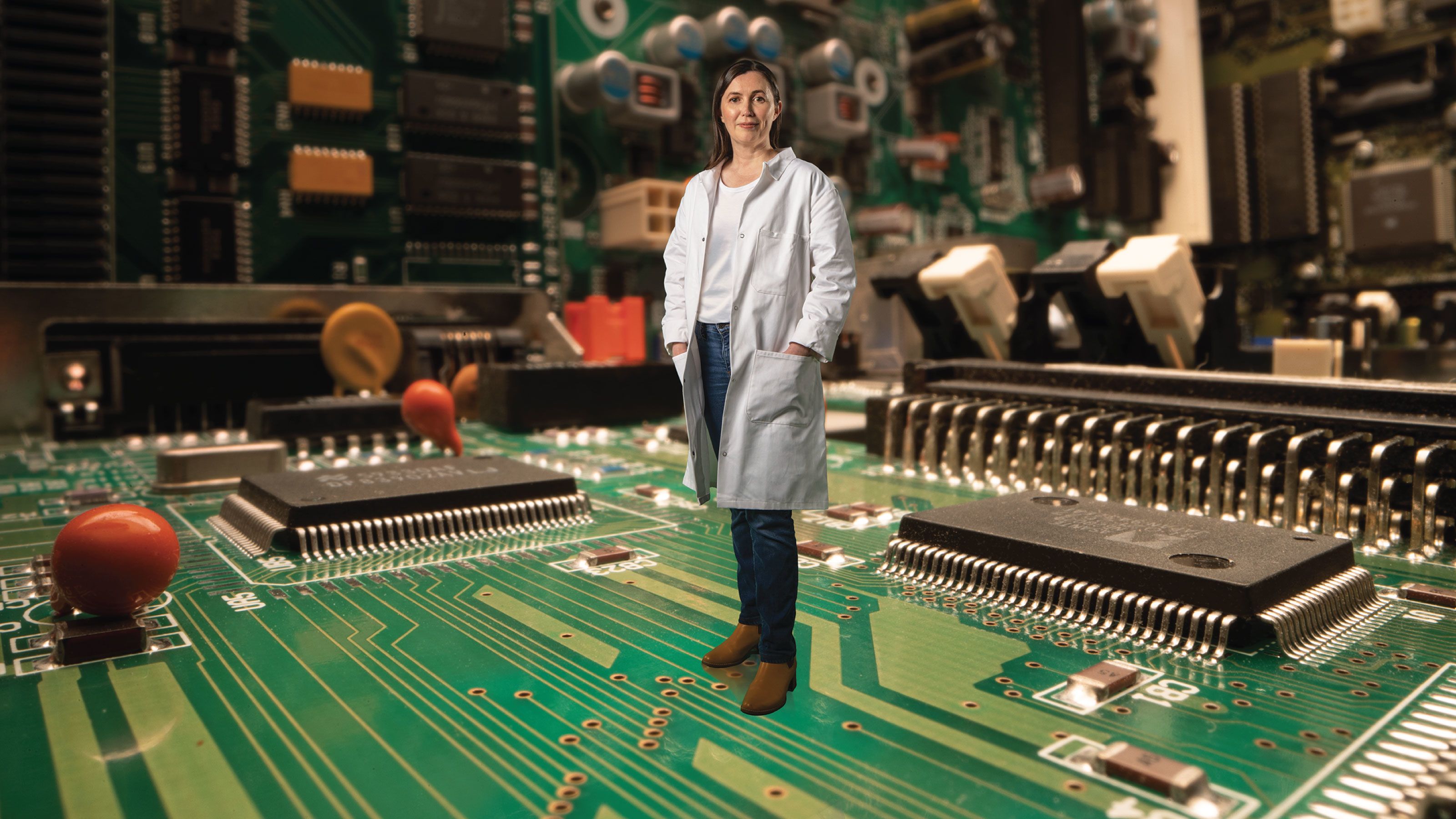 Associate Professor Natalie Plank appears to be standing on a small circut board.