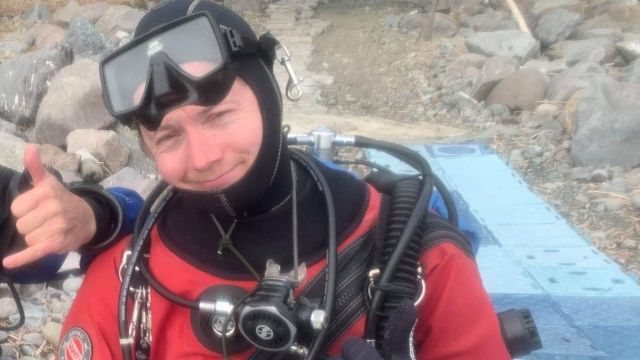 Man smiling in scuba diving gear