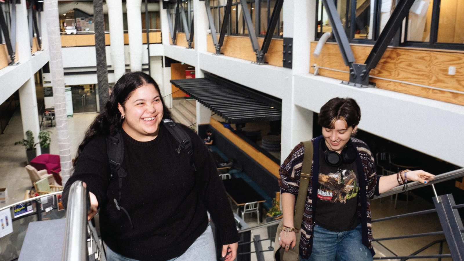 Two students walking up the steps in the Victoria University Hub.