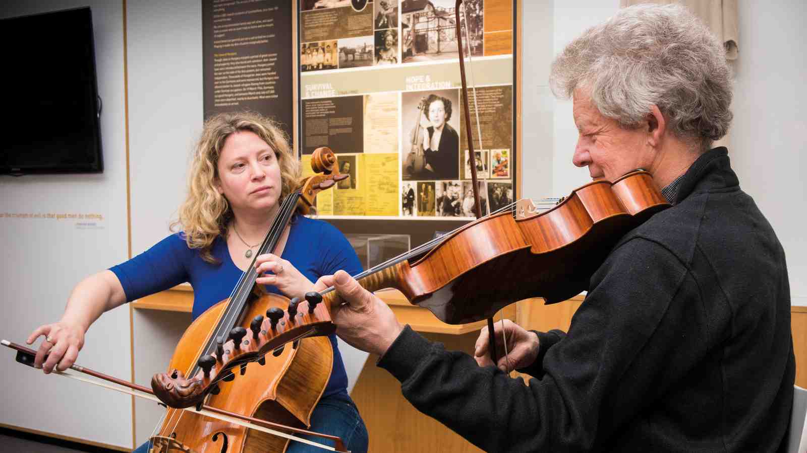 Senior Lecturer Inbal Megiddo and Professor Donald Maurice playing stringed instruments together.