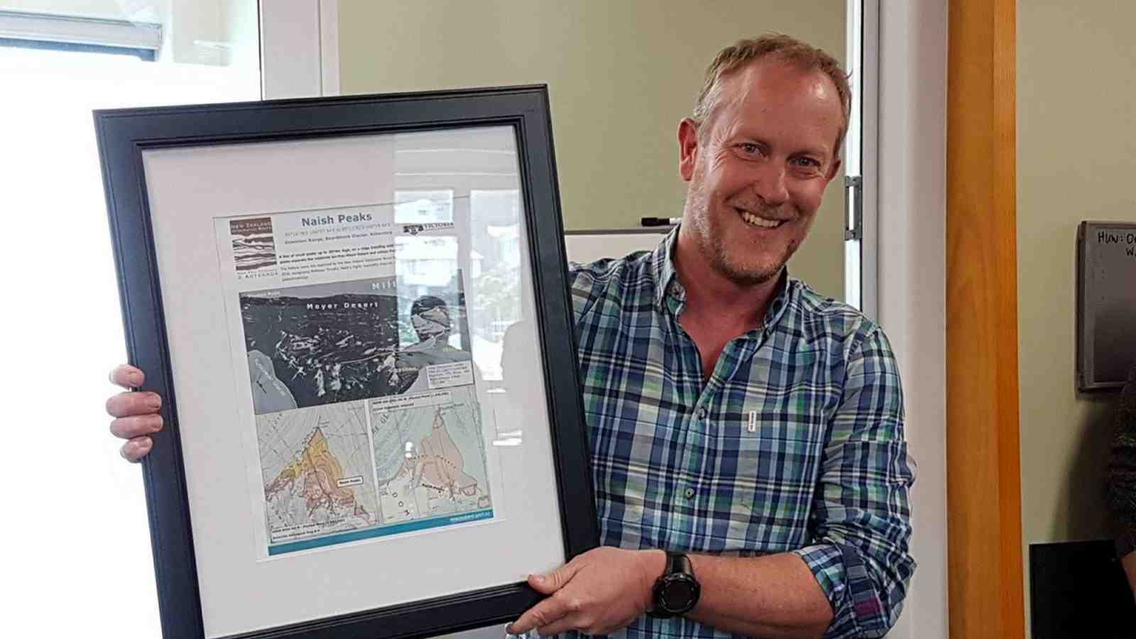 Tim Naish presented with a plaque for Naish Peaks.
