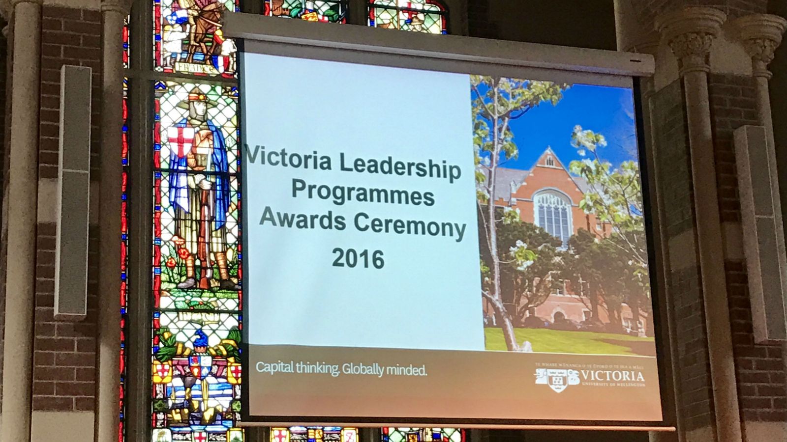 The banner of the Victoria International Leadership Awards 2016 against the backdrop of a beautiful stained-glass window.