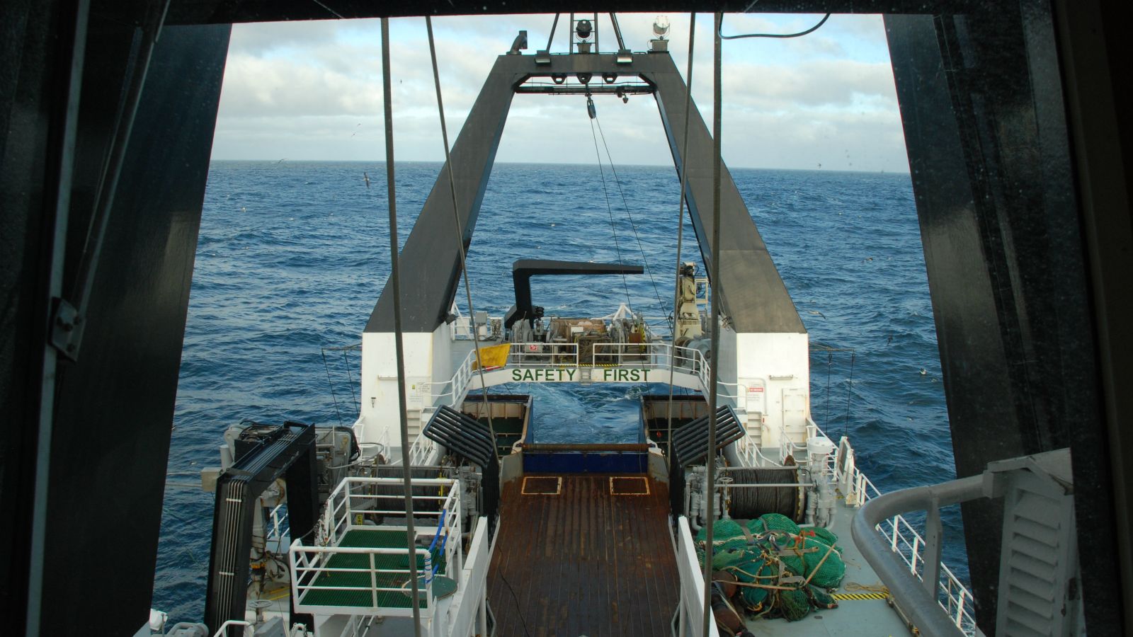 View from the captain’s deck of the Tangaroa on the Chatham Rise. The front of the ship is shown clearly with the ocean and various seabirds out ahead.