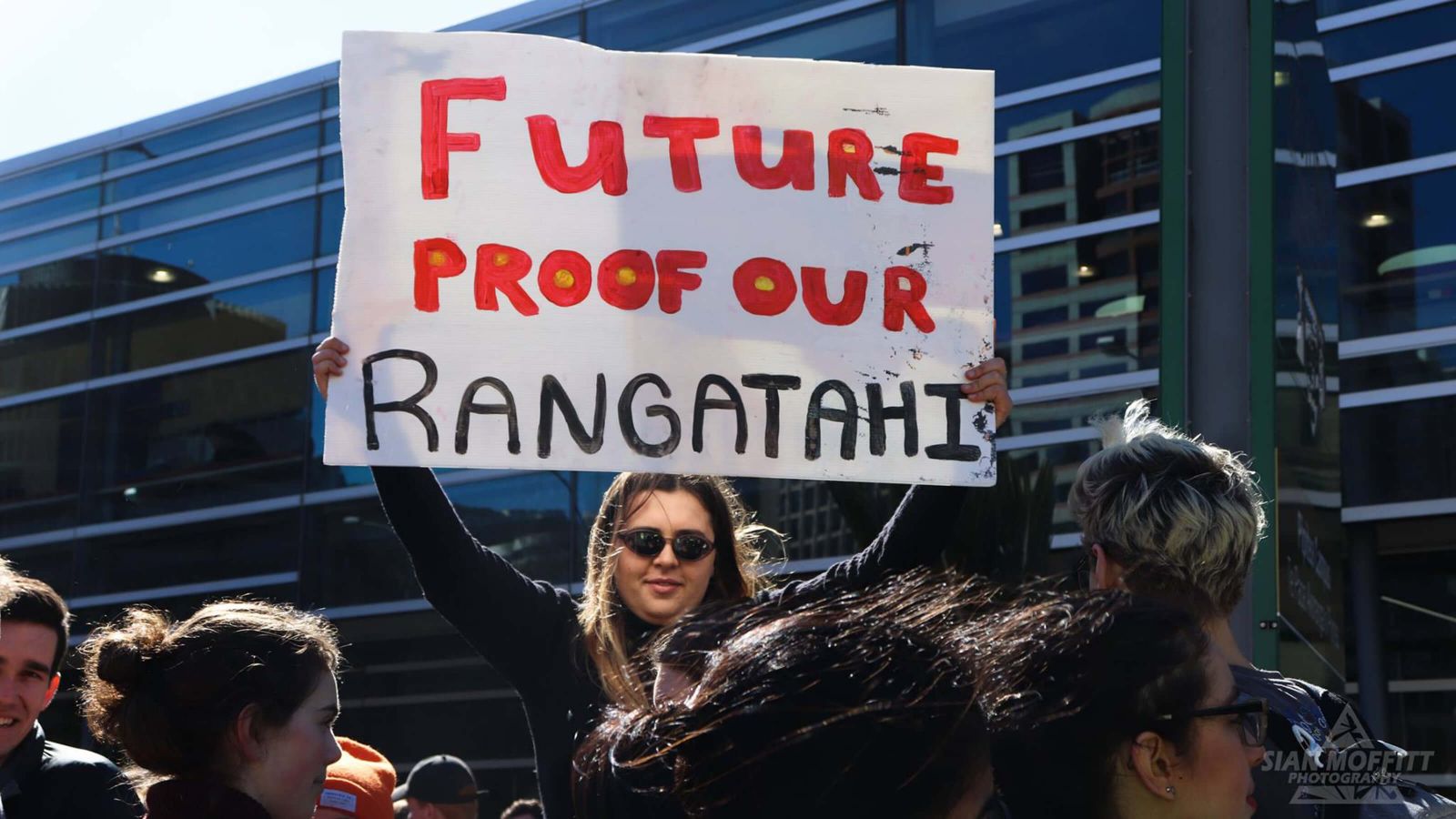 Student holding sign reading 'Future proof our rangatahi'