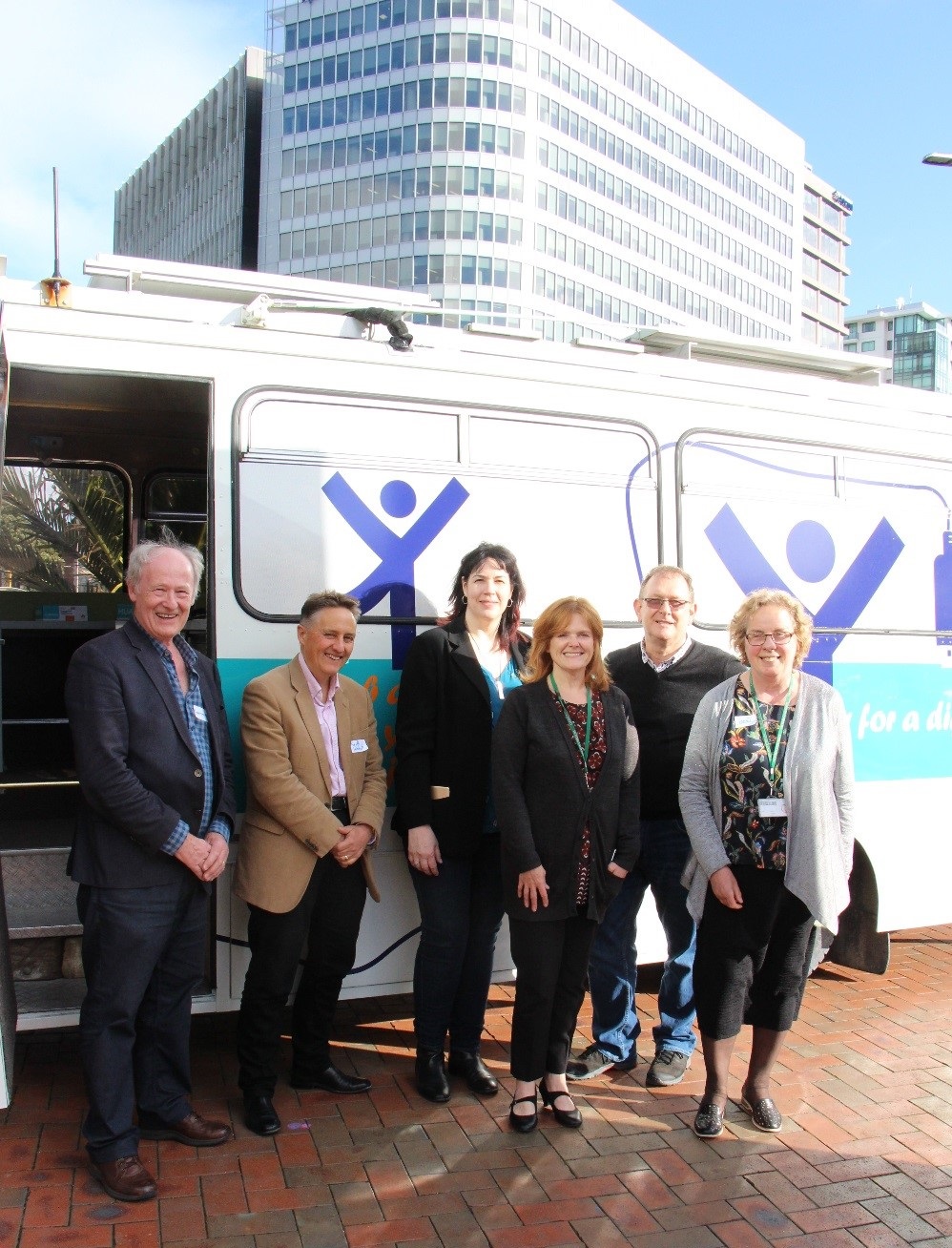 Staff in front of DORA, the mobile digital learning centre.