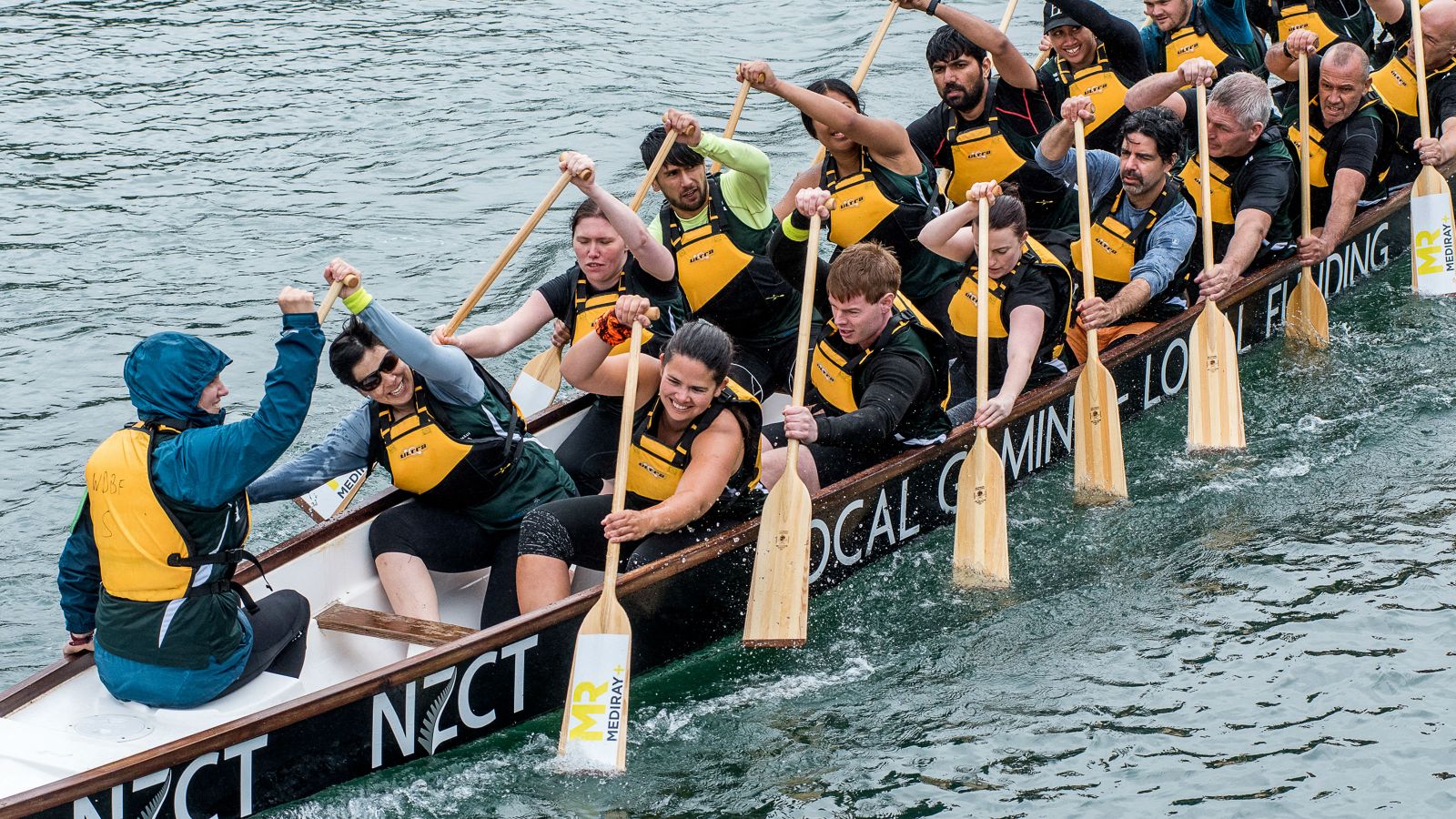 Dragonboat team members racing on Wellington Harbour.