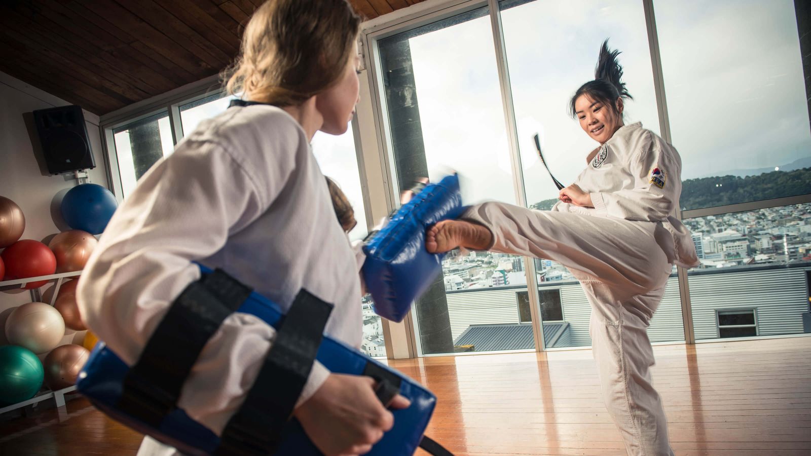 Two female students practicing judo kicks at the recreation centre on Kelburn campus..
