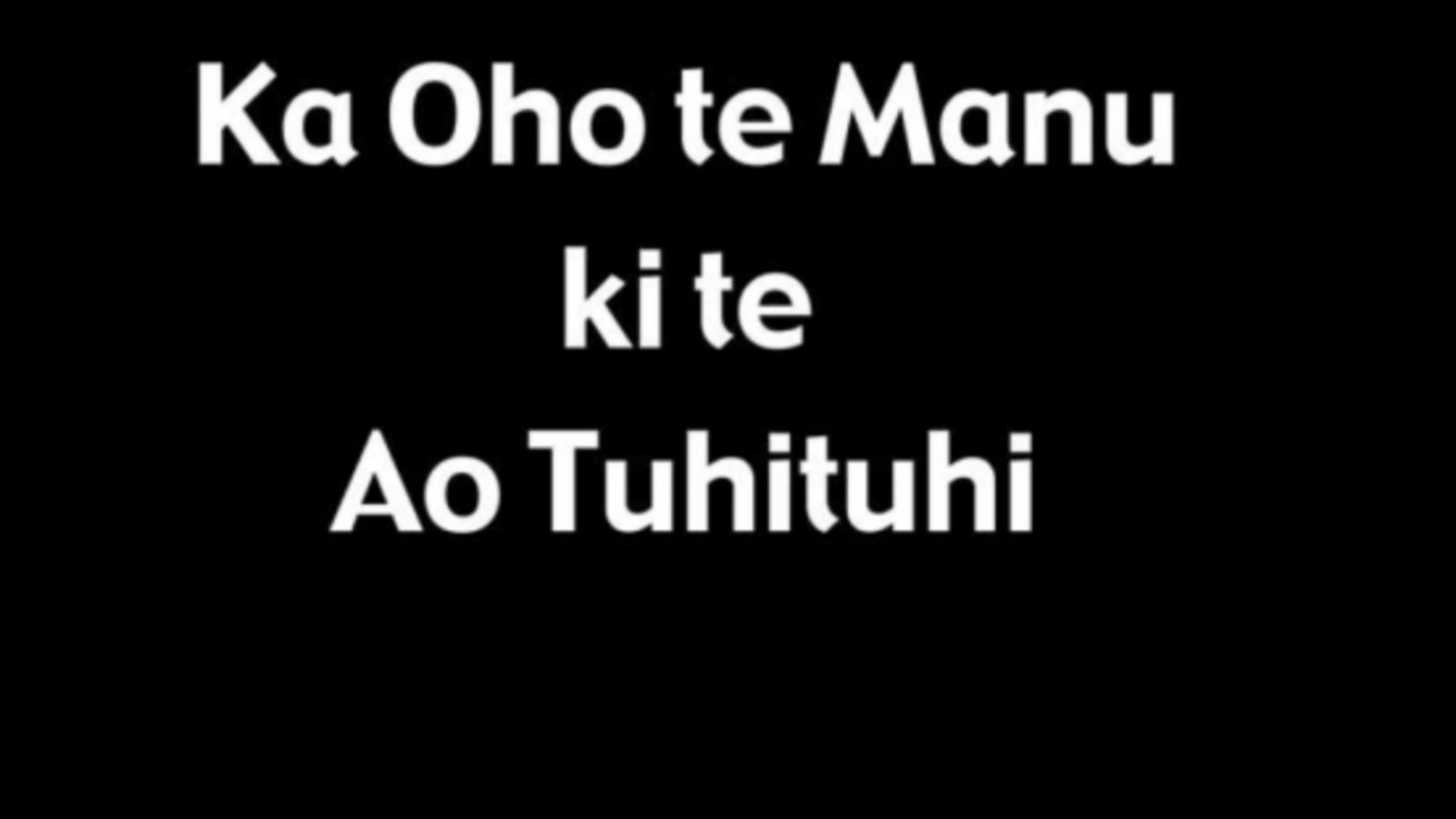 A black image with white text that reads, Ka Oho te Manu ki te Ao Tuhiluhi.