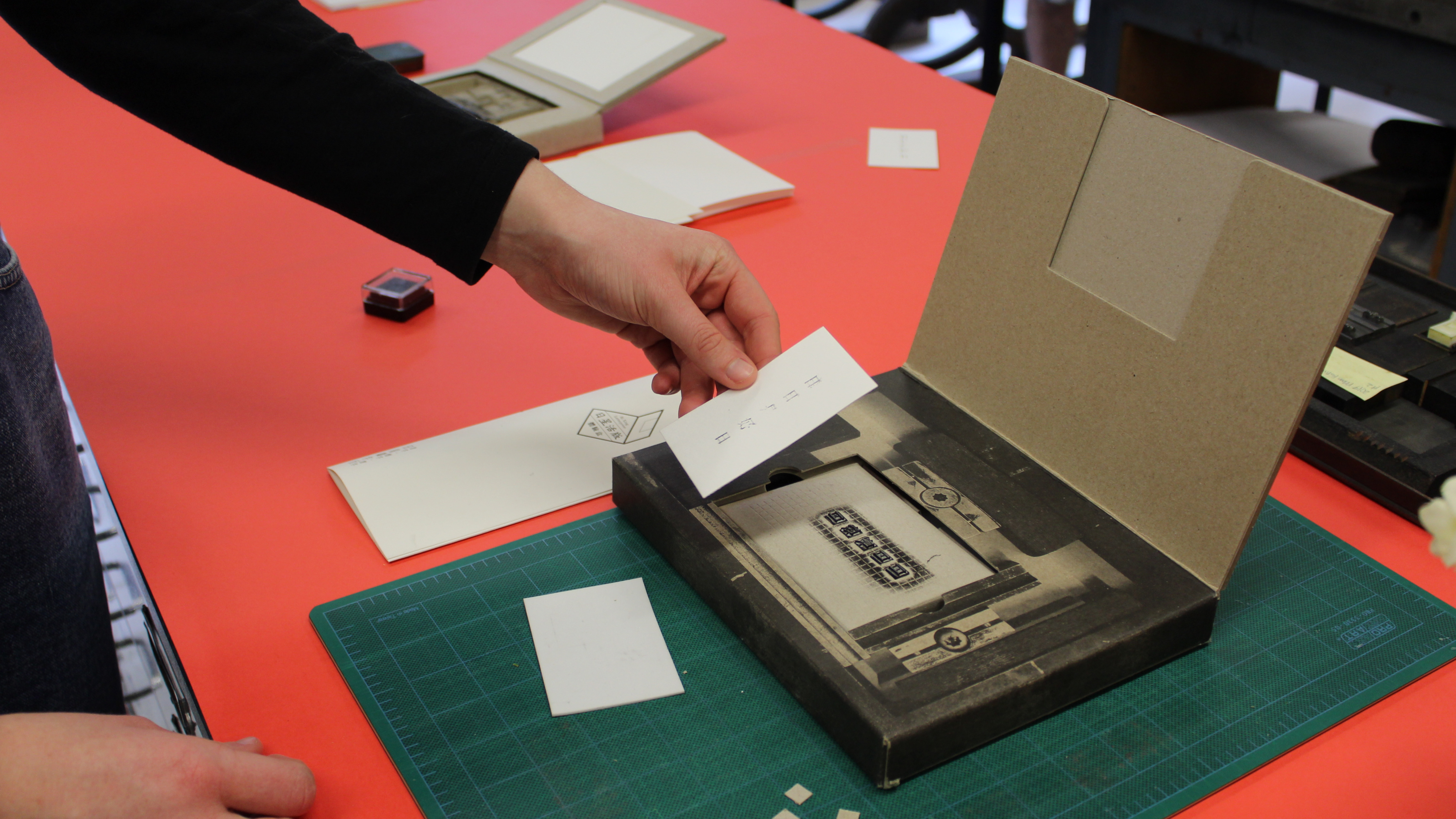 A guest prints a keepsake on a portable letterpress kit