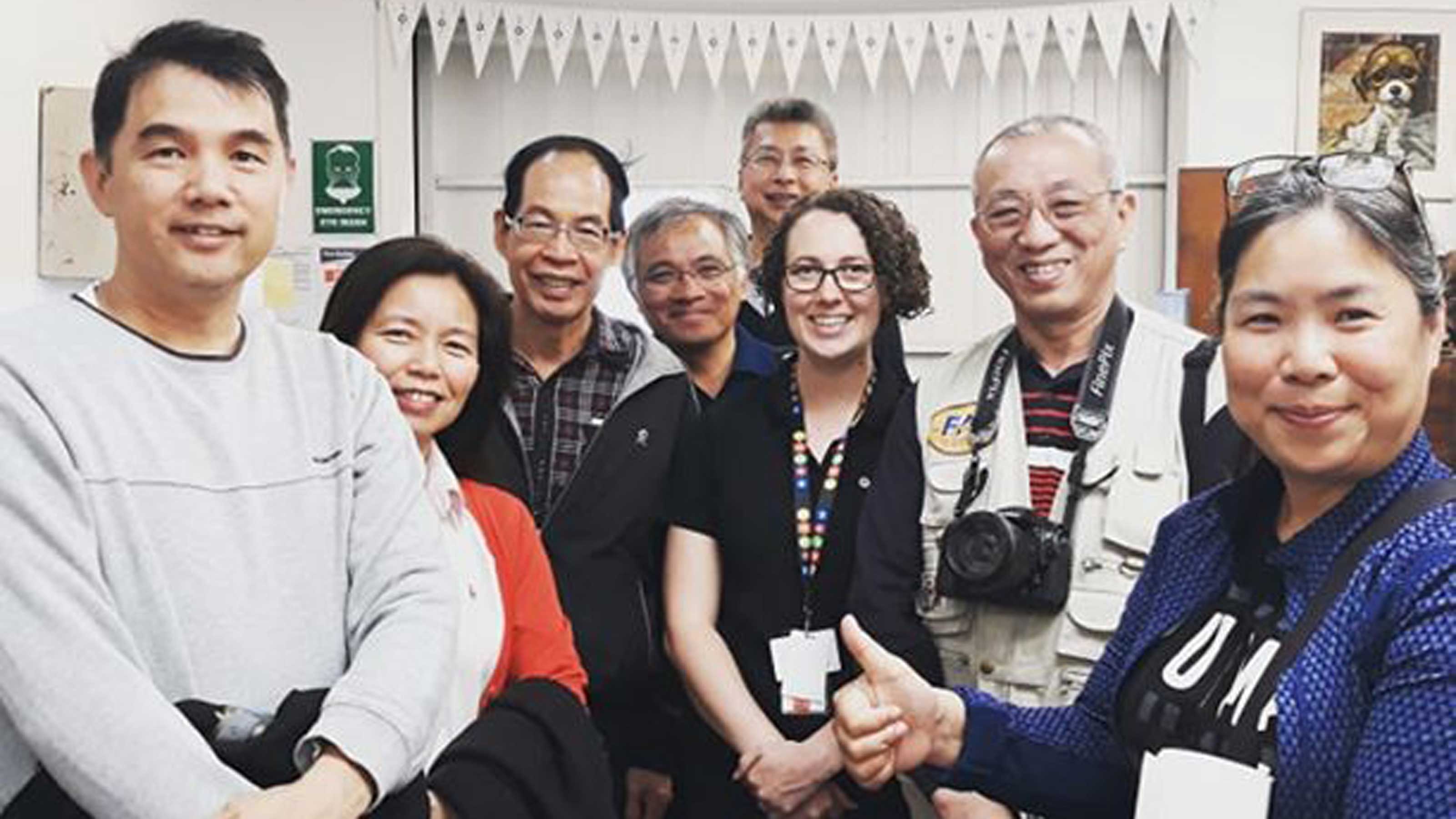 Seven Taiwanese visitors with Makyla Curtis at MOTAT print shop
