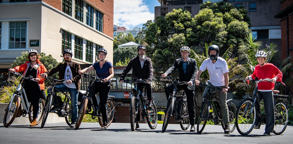 eBike riders pose with ebikes and bike accessories. 