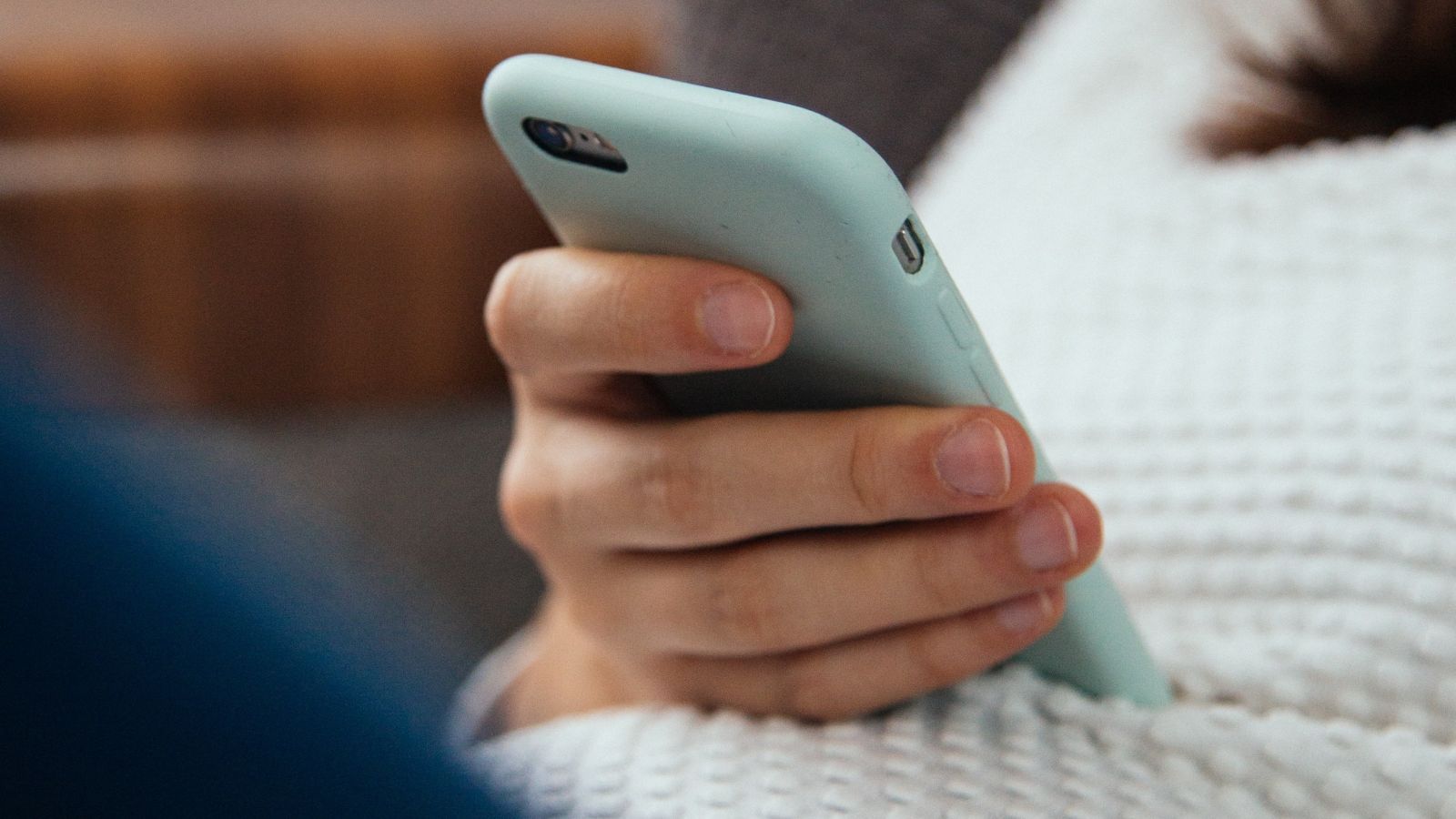 A pregnant woman holding a cell phone