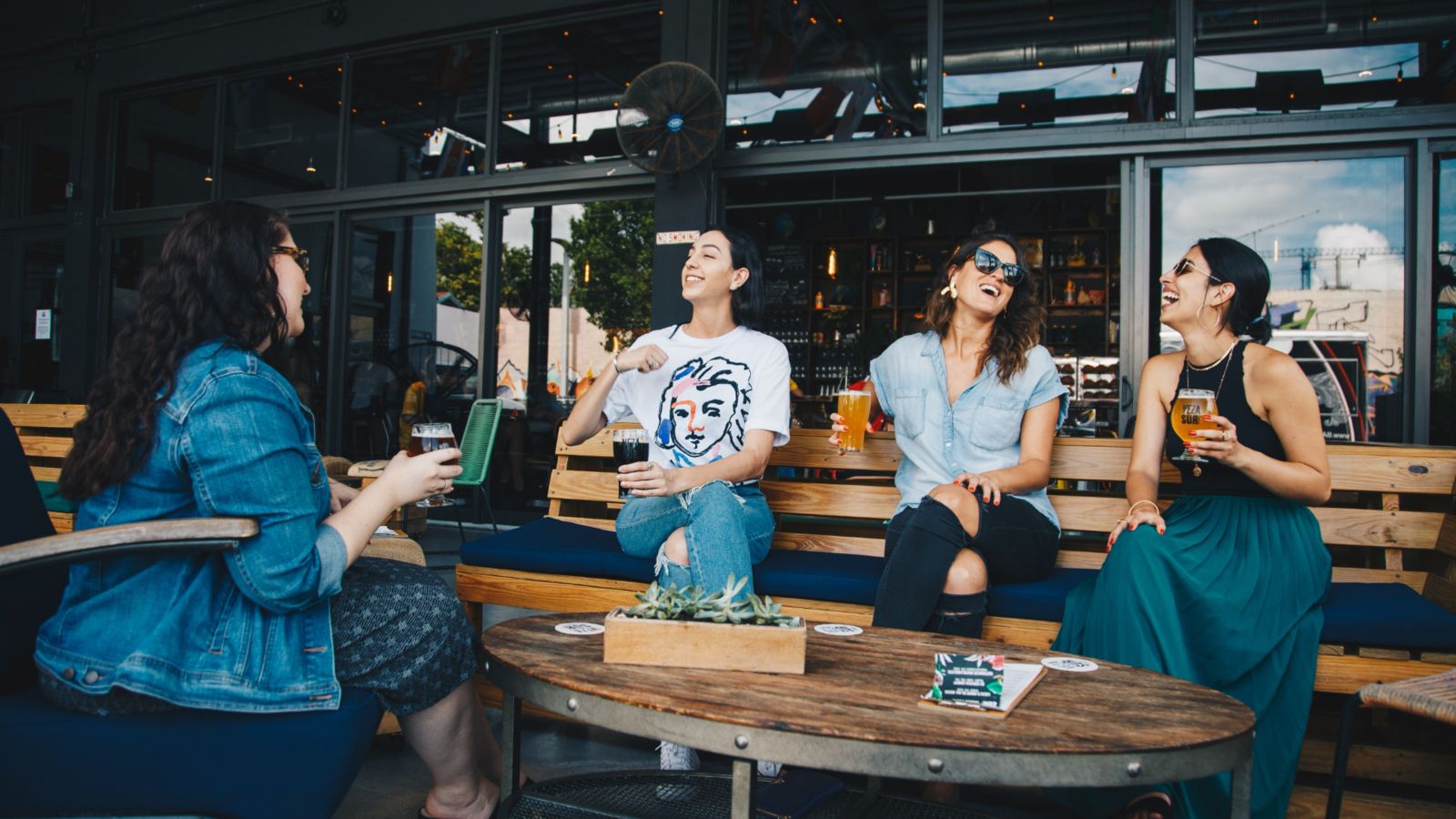 Young women at a bar having a conversation