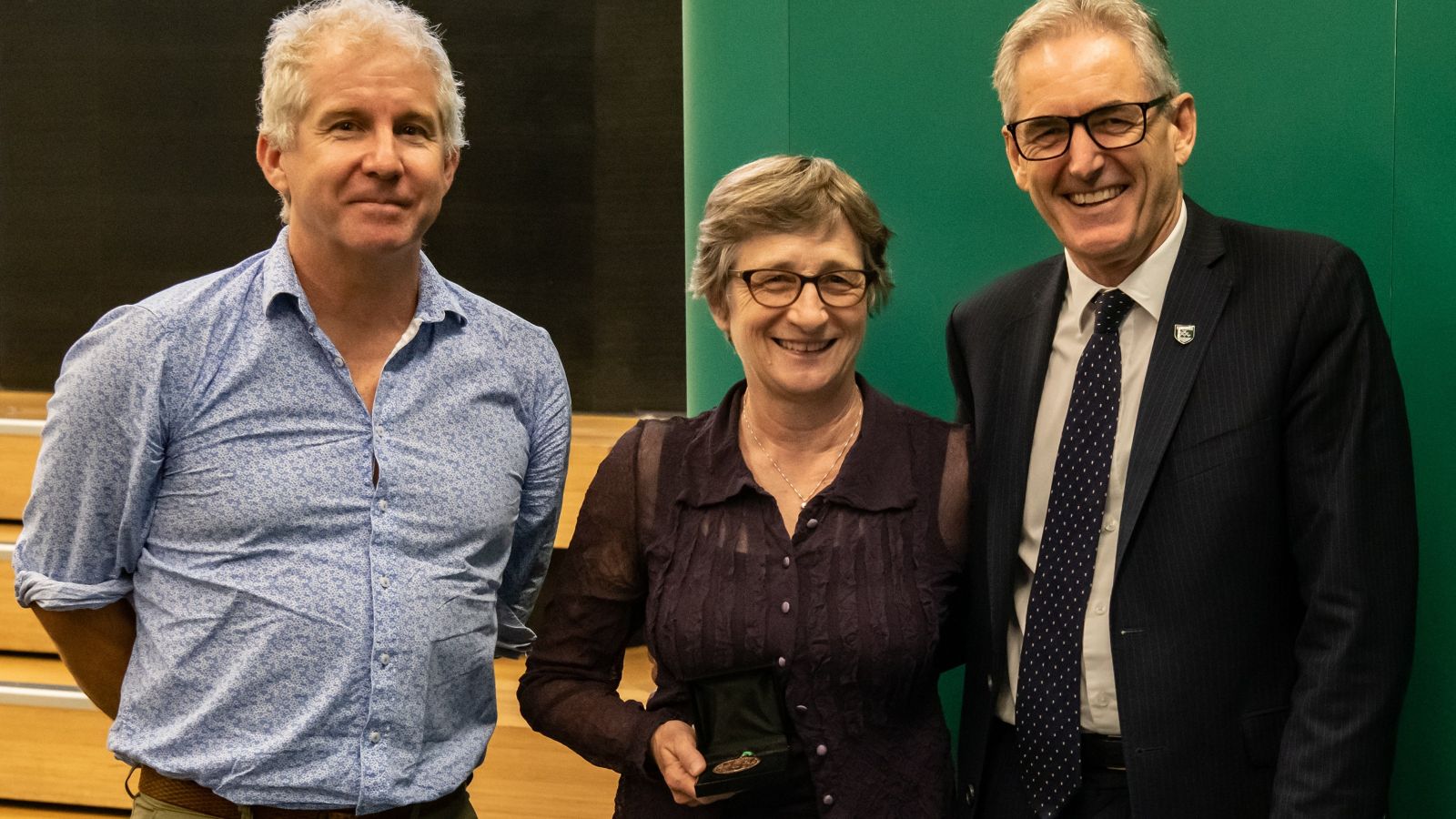 Professor Martha Savage, holding her Marsden Medal, with Dr Craig Stevens and Professor Grant Guilford