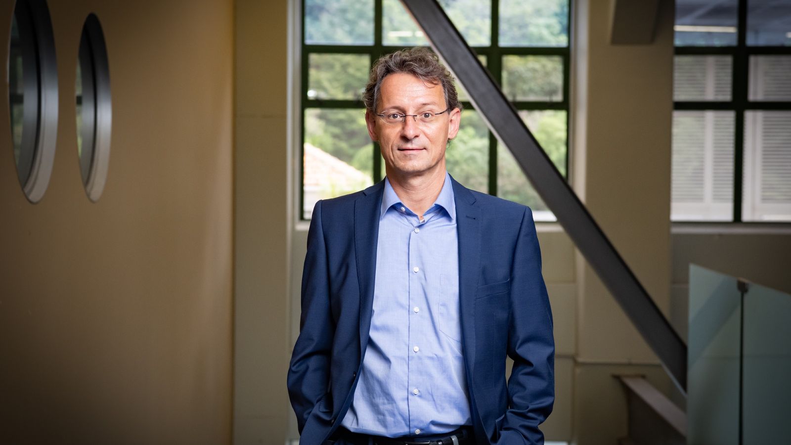 Image of Professor Markus Melloh in front a window. 