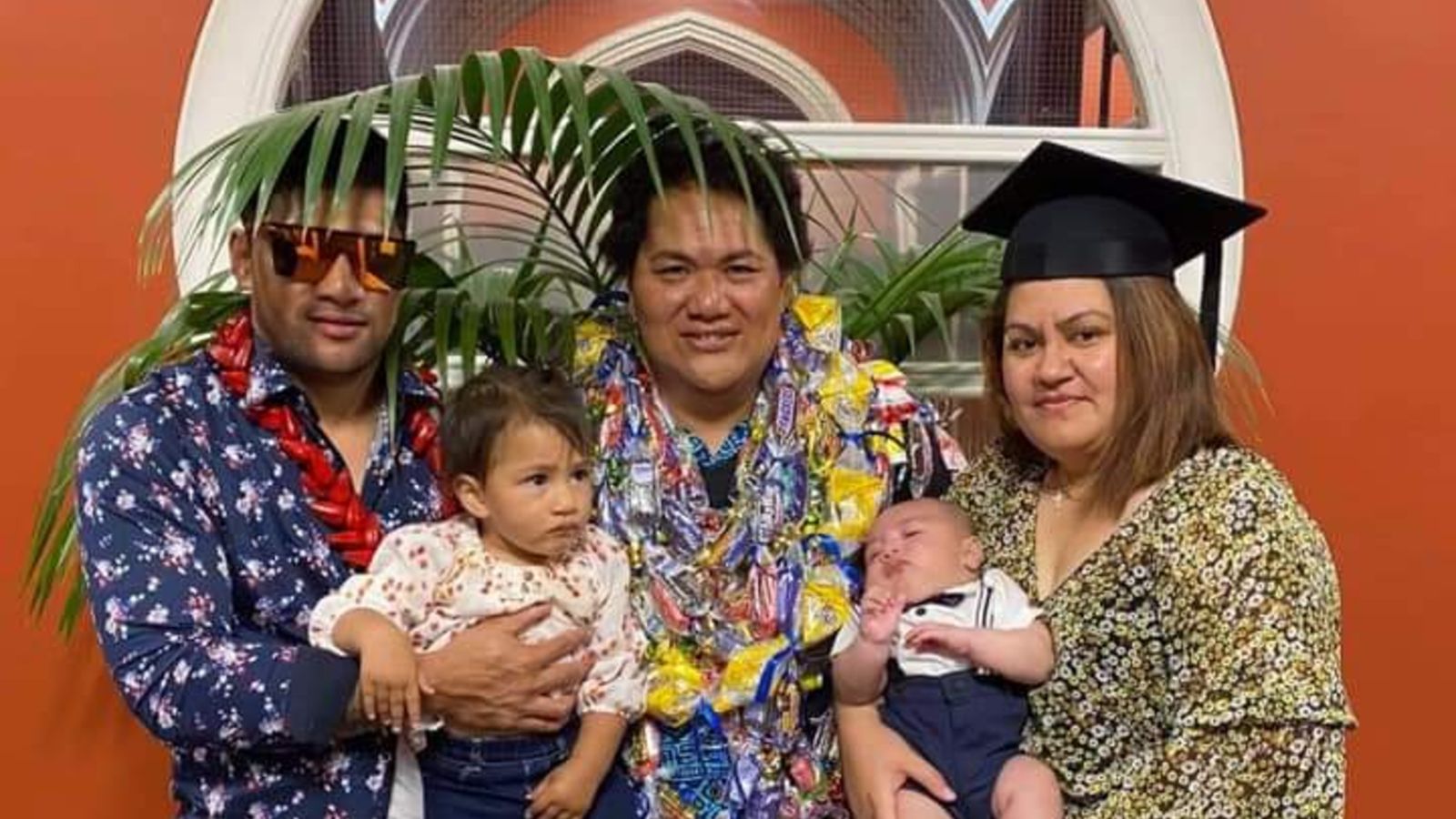 Samoan person standing with family at graduation