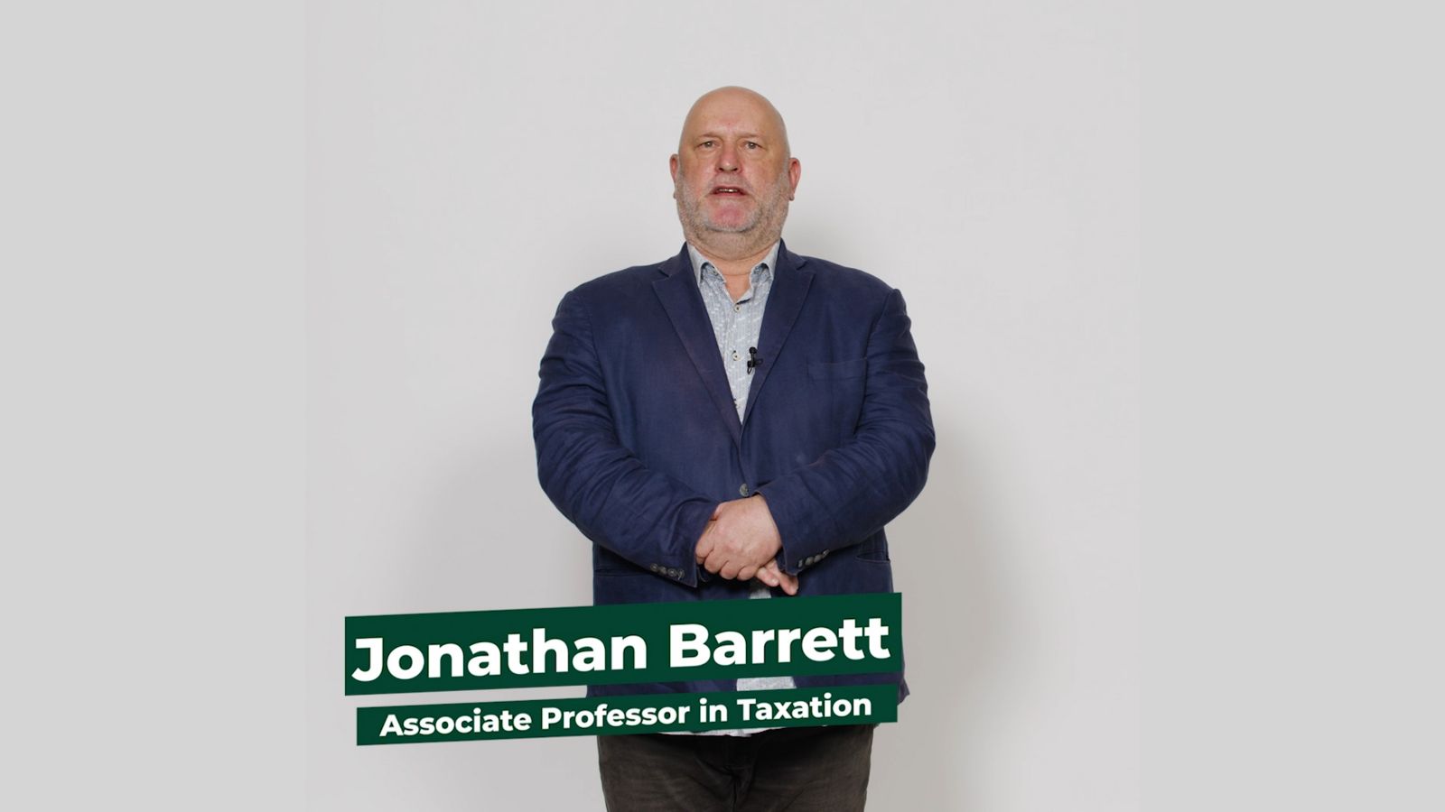 Associate Professor Jonathan Barrett stands facing the camera against a white background