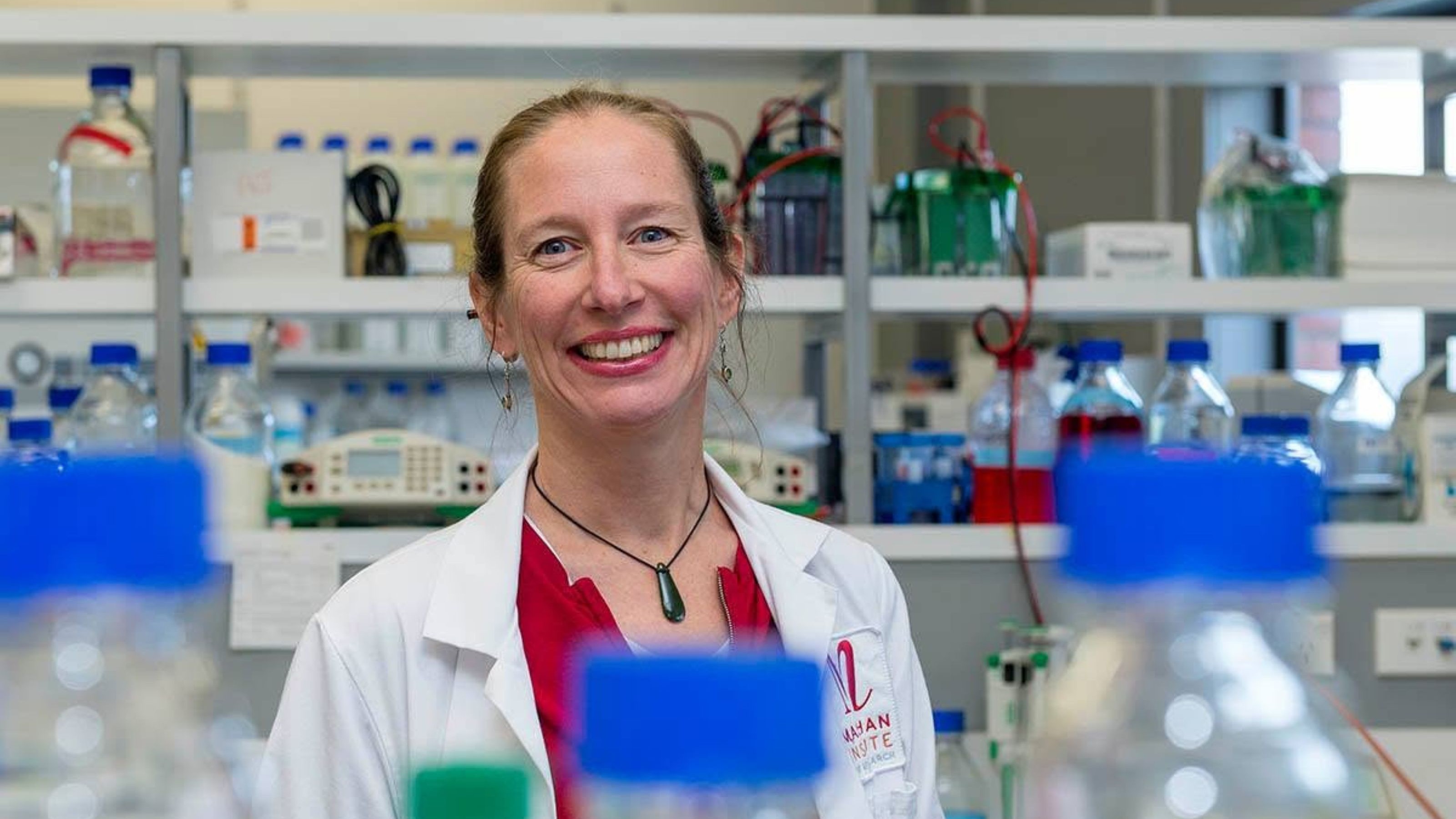 Professor Anne La Flamme standing in a chemistry lab. 