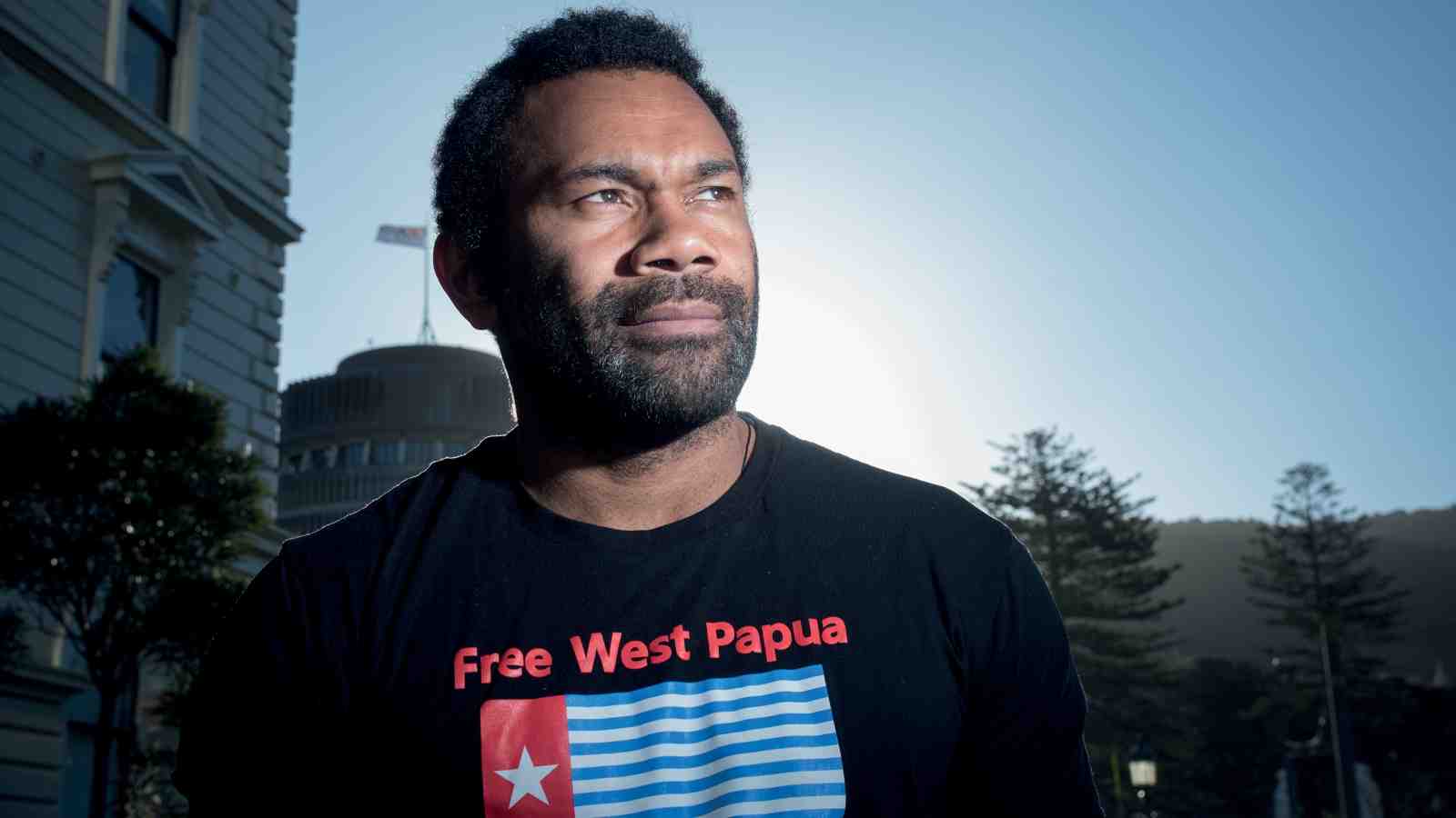 Dr Pala Molisa outside Victoria's Law School with the Wellington Beehive in the background.