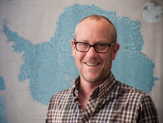 Tim Naish in front of a map of Antarctica 2014
