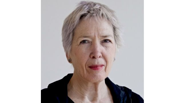 Sally-Jane looks into the camera, smiling.