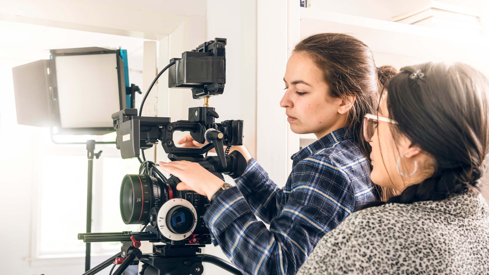 Two female students filming inside the Miramar Creative Centre.