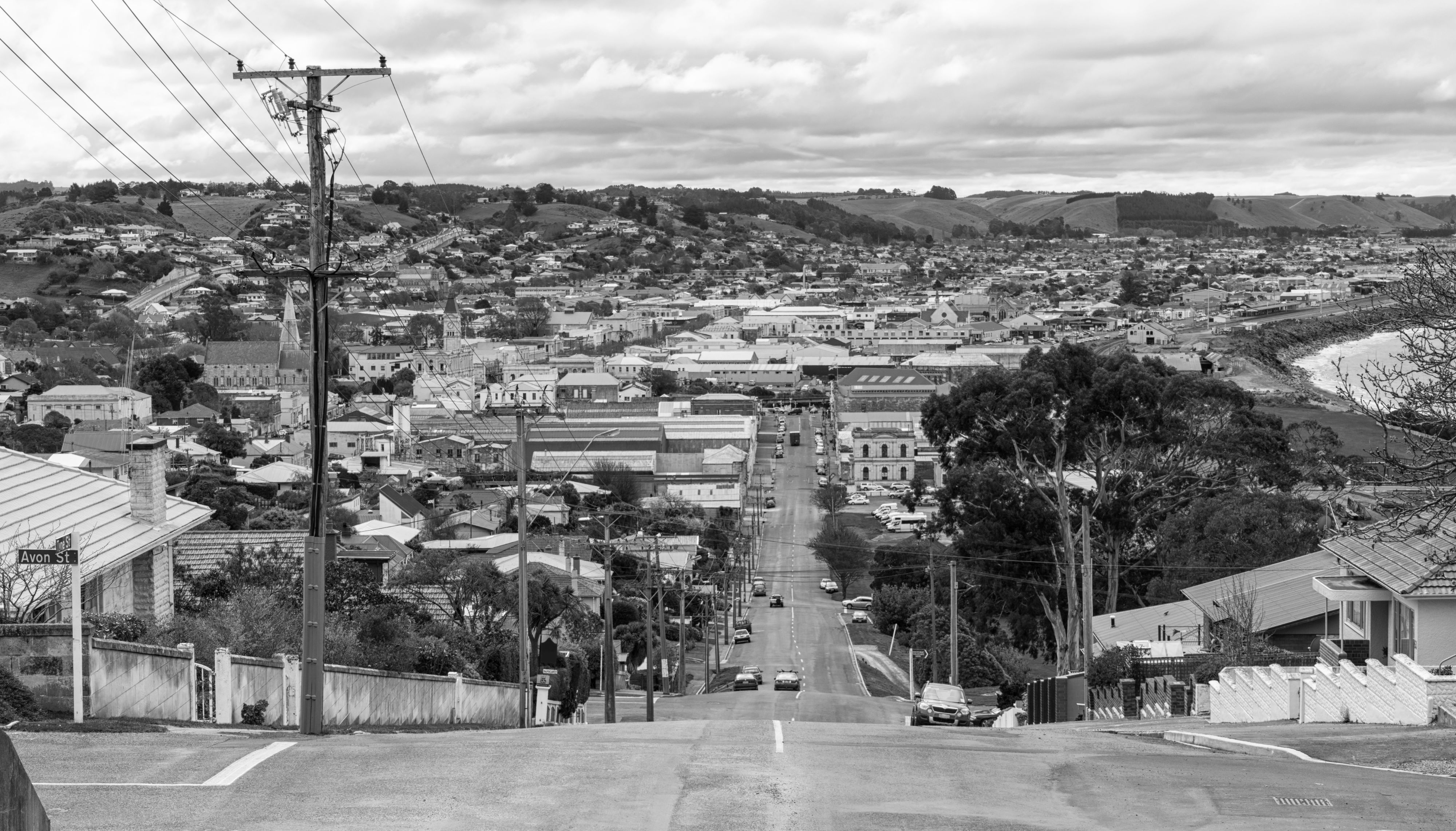 Black and white photo of a New Zealand suburban road.