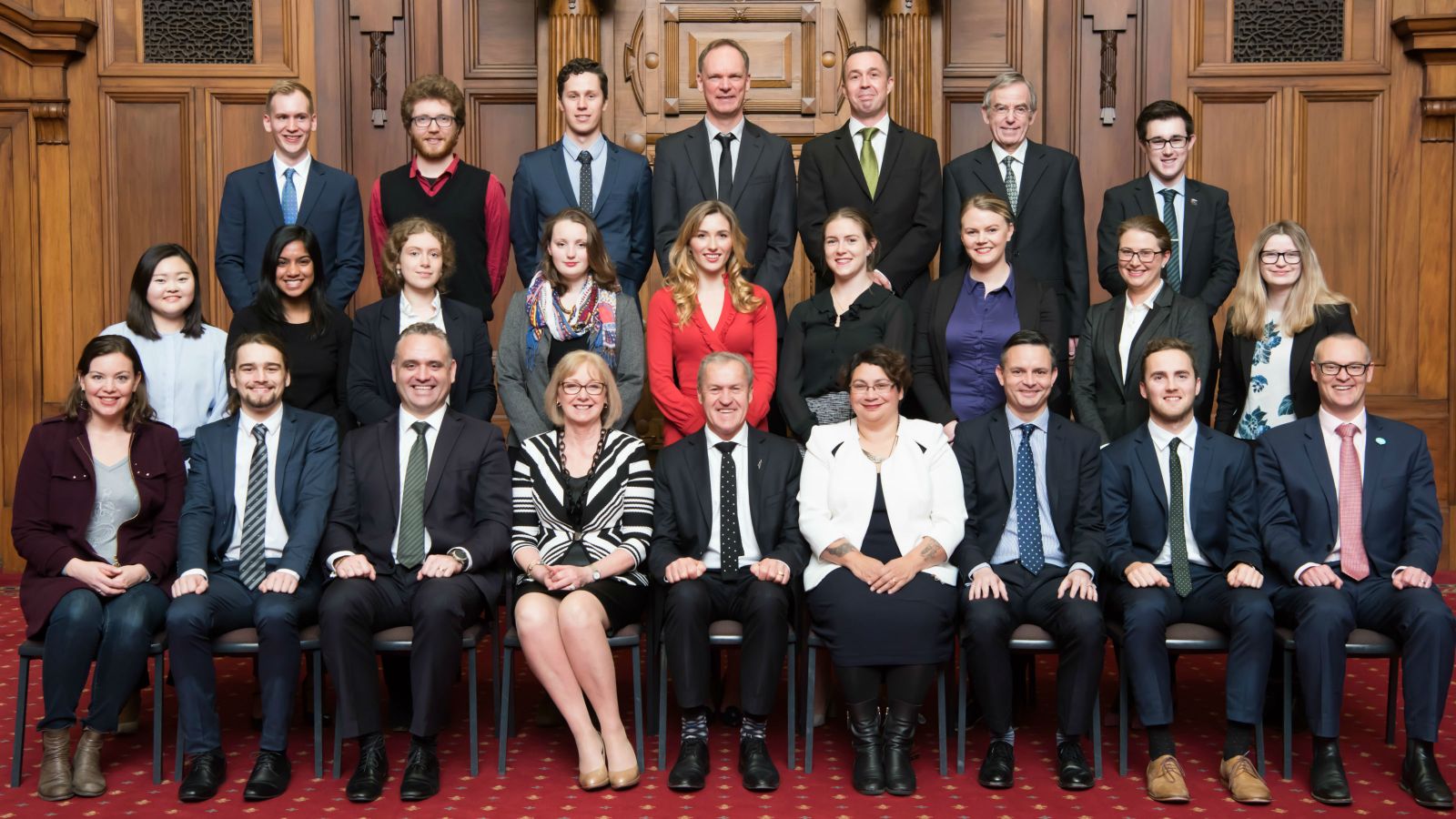 Parliamentary Internship Programme class photo, 2017, showing interns with their MPs, parliamentary staff, course coordinator Professor Stephen Levine, and with the Speaker, Rt Hon David Carter: photograph taken in the Legislative Council Chamber, Parliament (by VUW Image Services).
