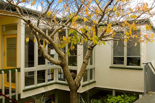 Tree with autumn leaves in front of Bill Manhire House, Institute of Modern Letters