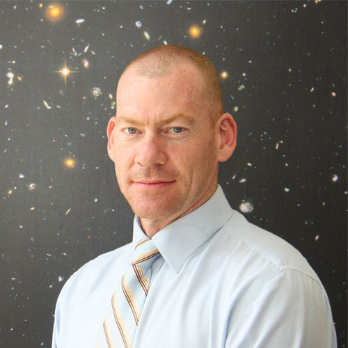 Picture of Professor Steven Tingay with a backdrop of astronomical imagery.