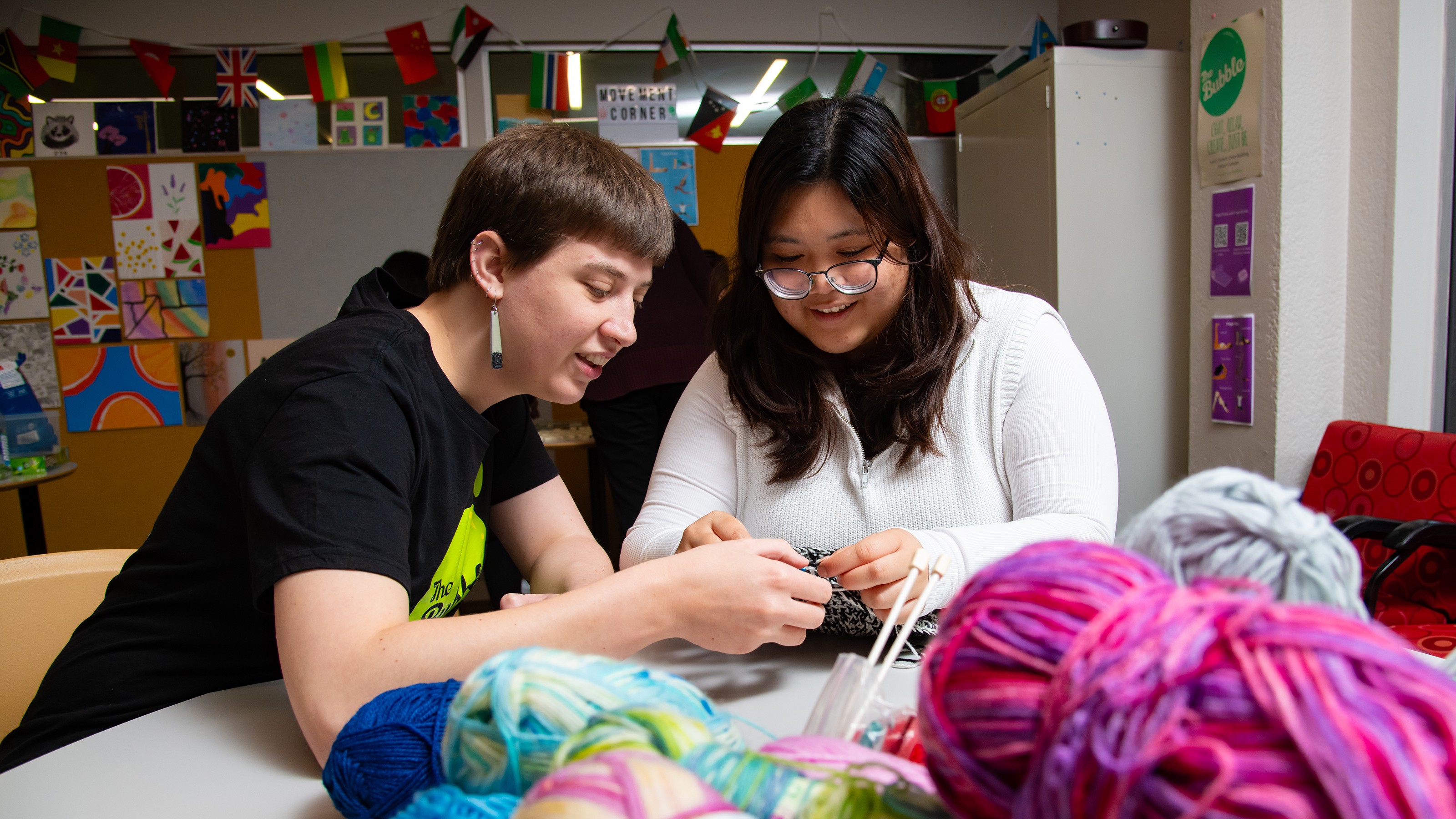 Two students learning how to knit and crochet in The Bubble.