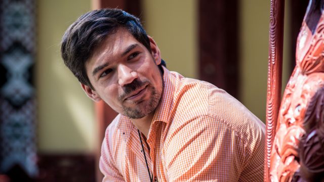 Vini smiles at someone to the right of the camera.