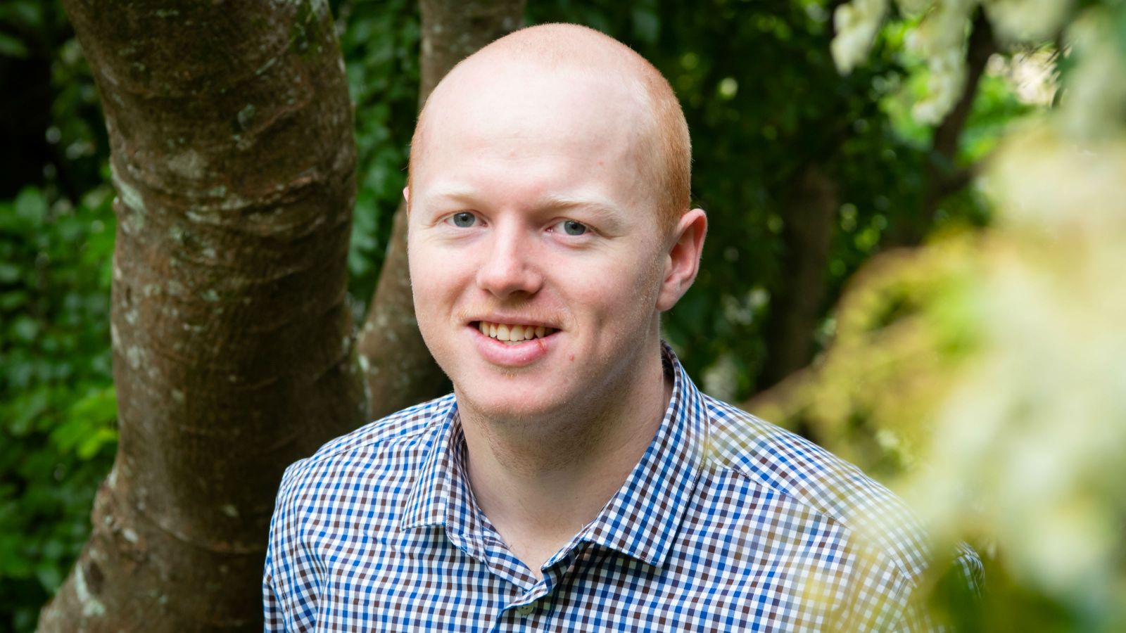 Jakob Parrish standing outside amongst vegetation