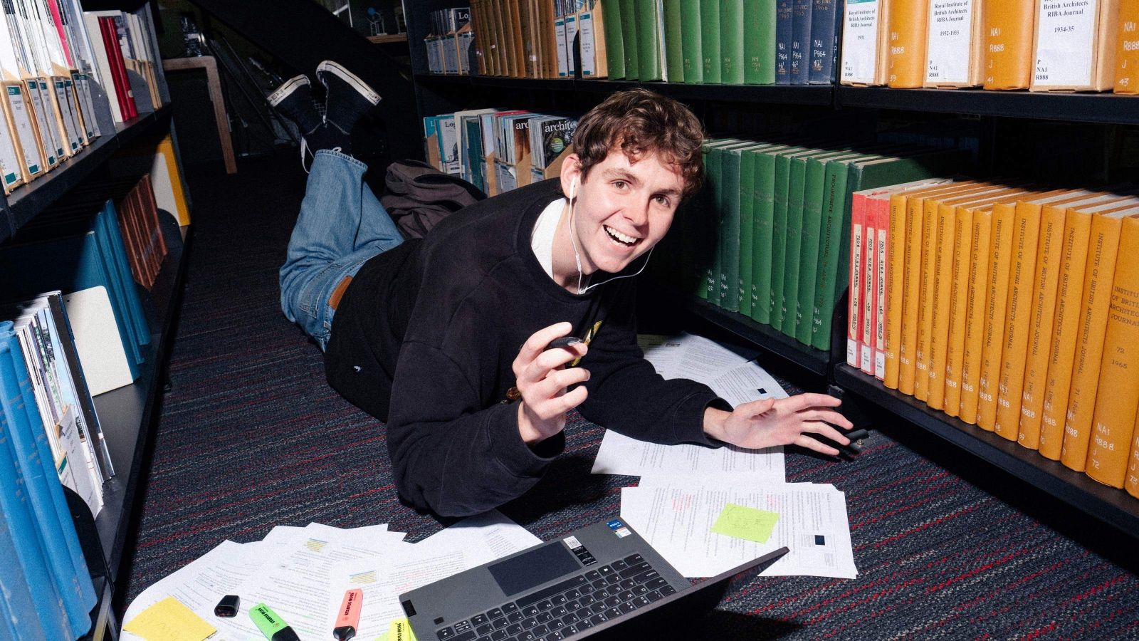 Student smiling while studying in the Library